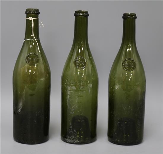 Three 19th/20th century sealed wine bottles, embossed seal F M 30cm high